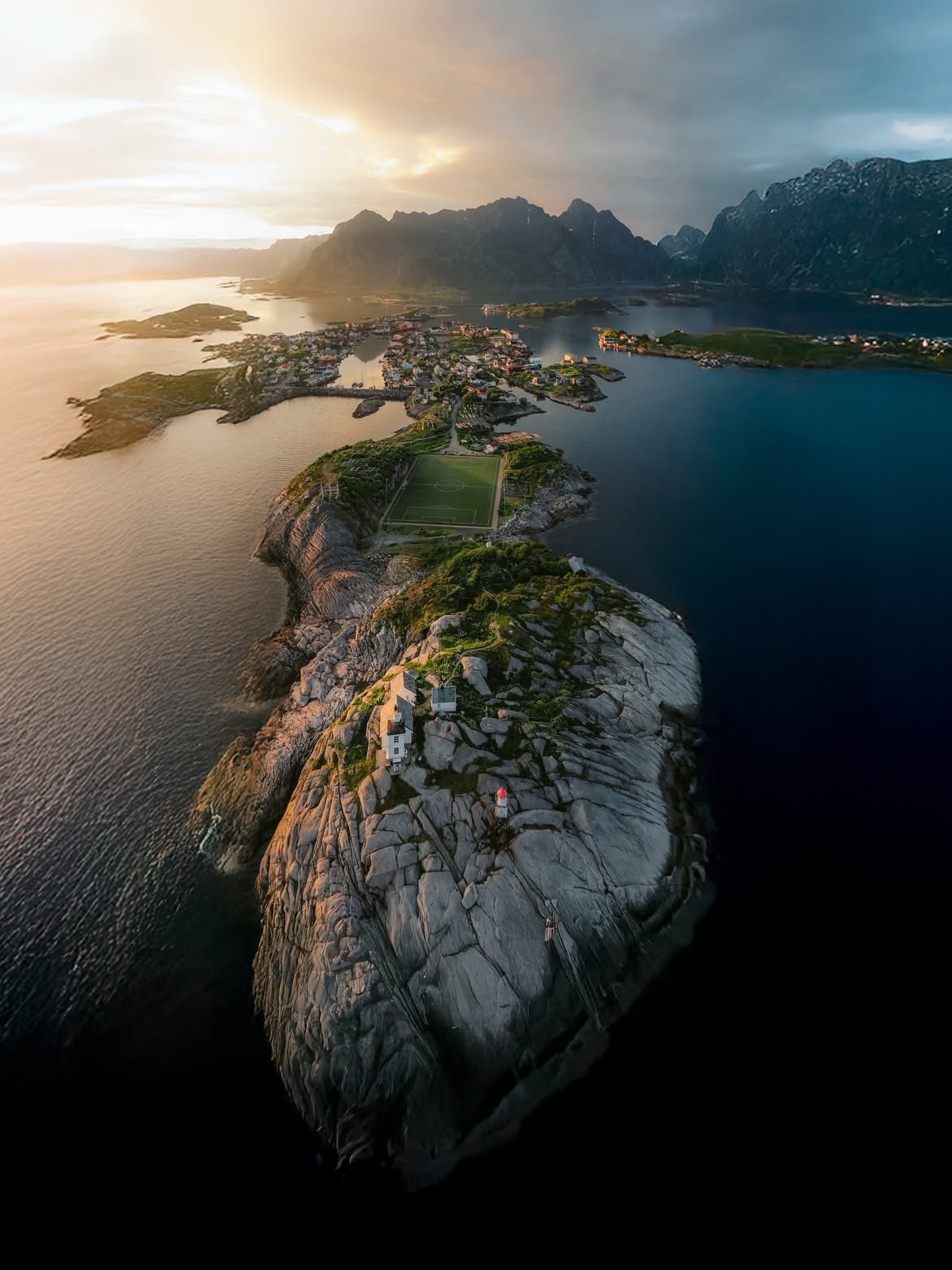 Henningsvær from the air in low golden light