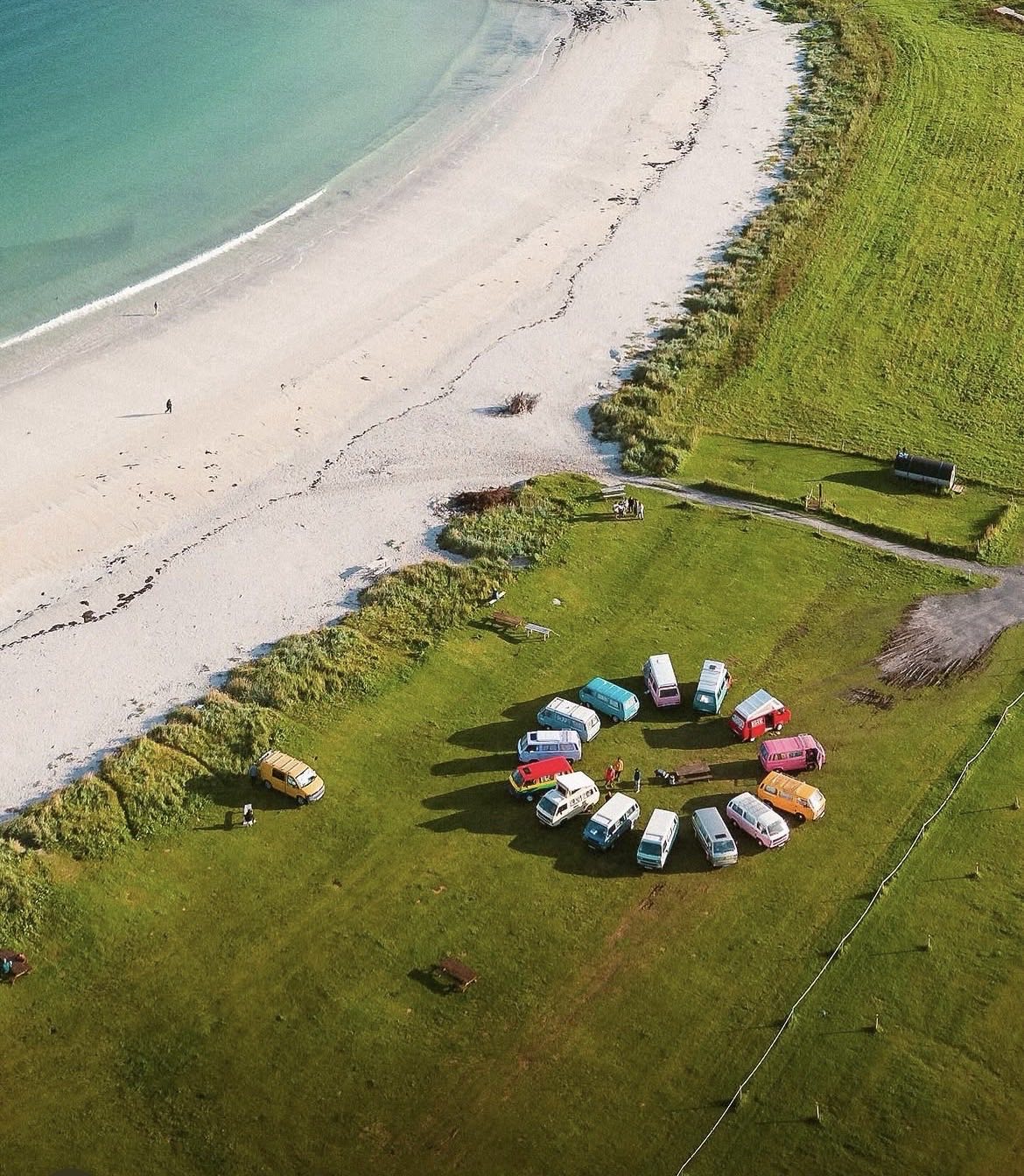 The campers pitched on grass directly behind a white sand beach