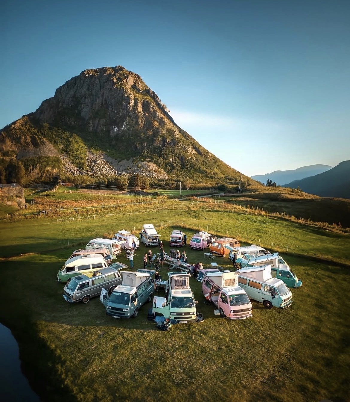 The campers parked in a circle on grass with the group between them
